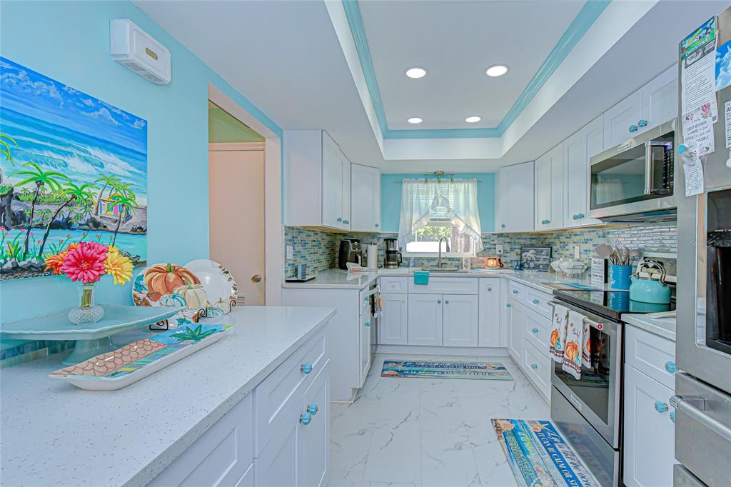 9700 Starkey Road, Unit 111 Seminole, FL 33777 - Photo 10 of 46 a kitchen that has a lot of cabinets and window