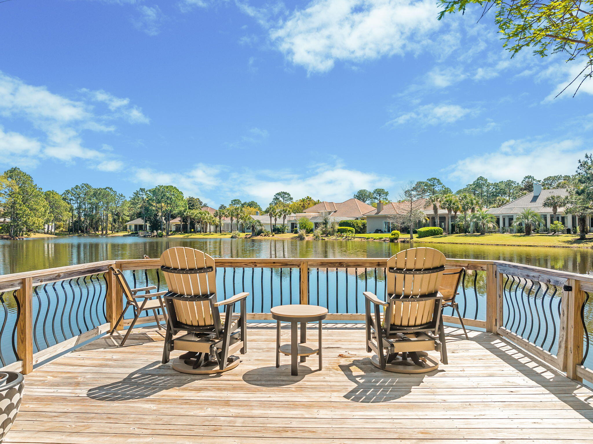 437 Admiral Court Destin, FL 32541 - Photo 15 of 100 a view of a lake with table and chairs next to a yard