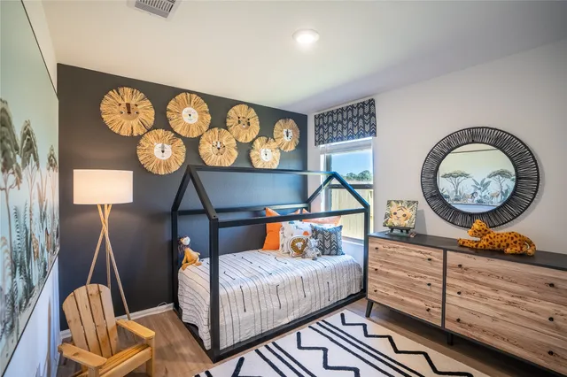 a bedroom with a bed and wooden floor