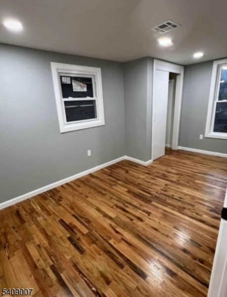 149 3rd Street Elizabeth Port, NJ 07206 - Photo 3 of 6 a bedroom with a bed and a window