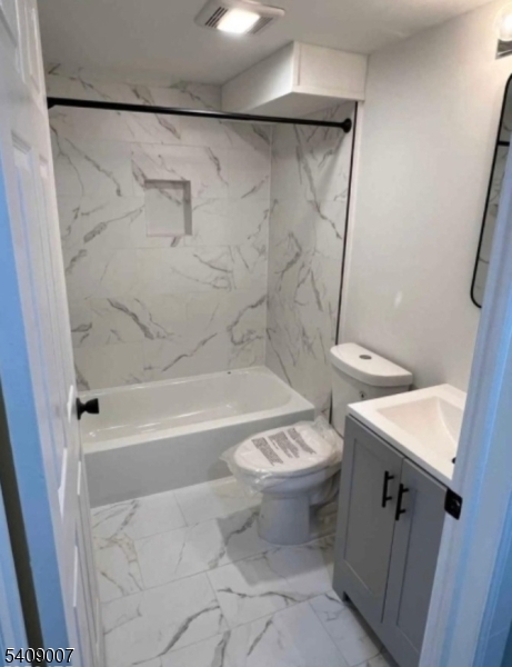 149 3rd Street Elizabeth Port, NJ 07206 - Photo 5 of 6 a white toilet sitting next to a bath tub