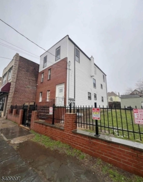 149 3rd Street Elizabeth Port, NJ 07206 - Photo 6 of 6 a view of a house with wooden fence