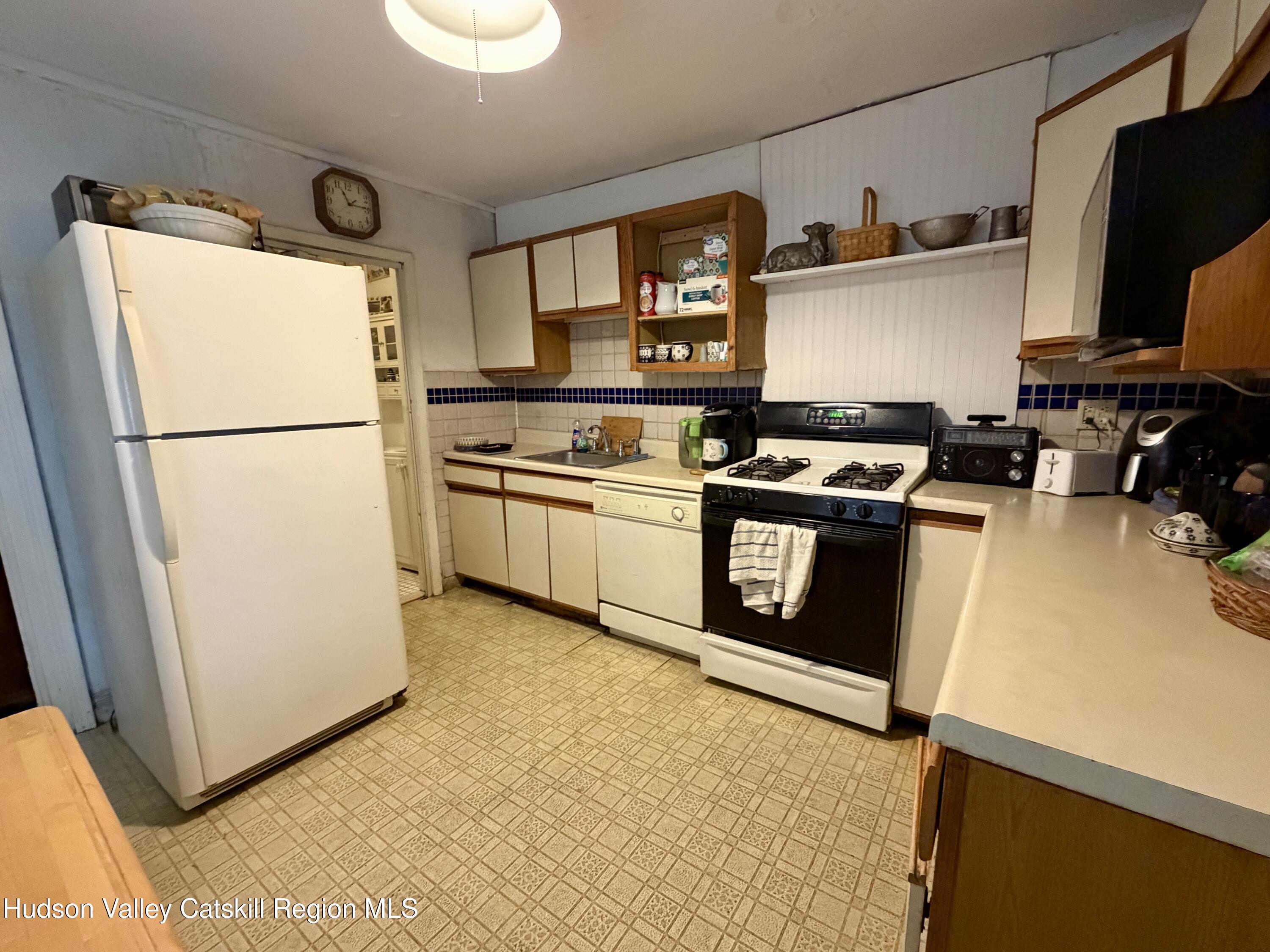 20 8th Street Hudson, NY 12534 - Photo 11 of 29 a kitchen with stainless steel appliances granite countertop a refrigerator a stove a sink and a microwave