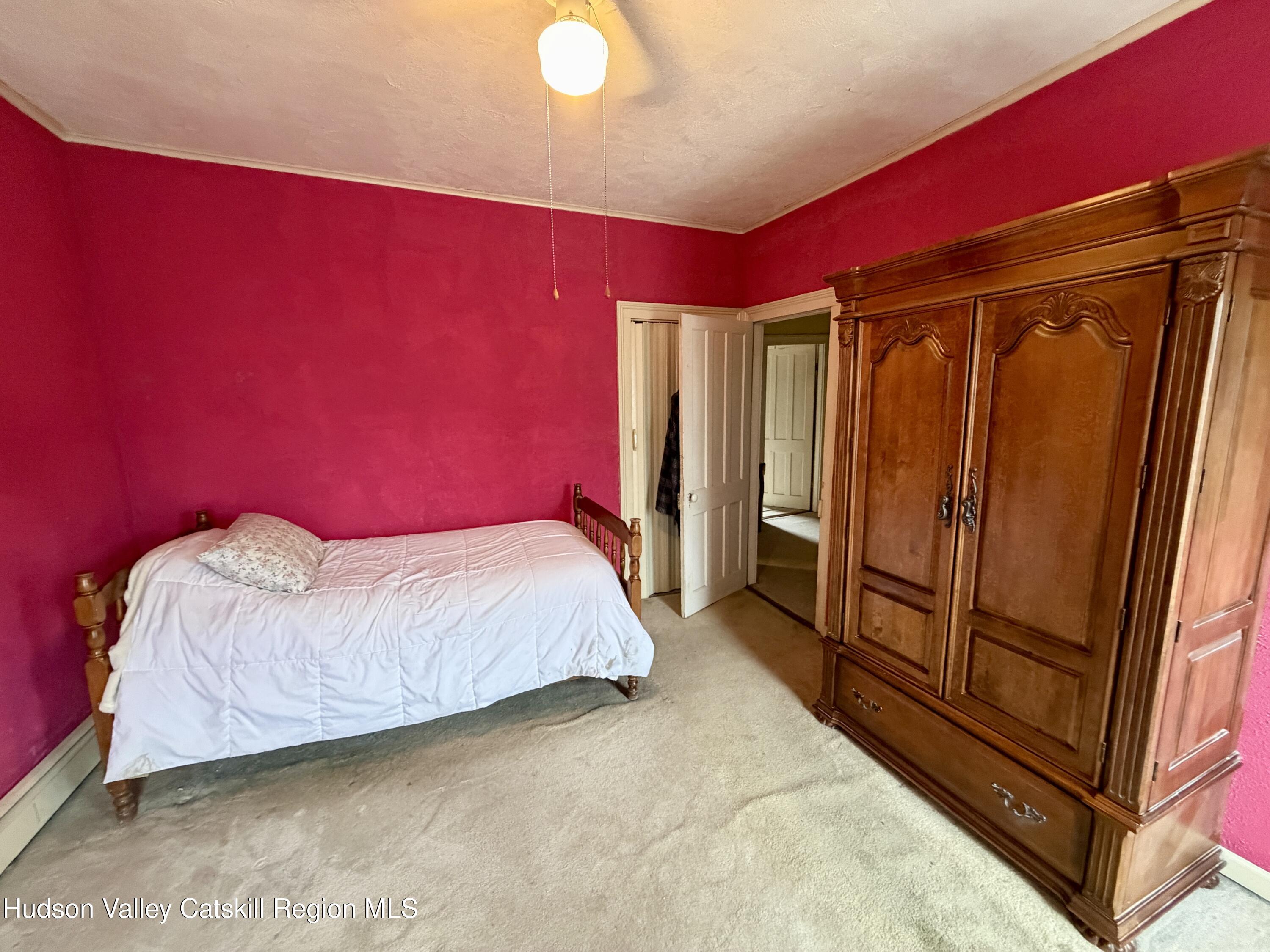 20 8th Street Hudson, NY 12534 - Photo 19 of 29 a bedroom with a bed and a mirror