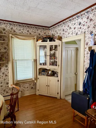 a room with a dresser and a window