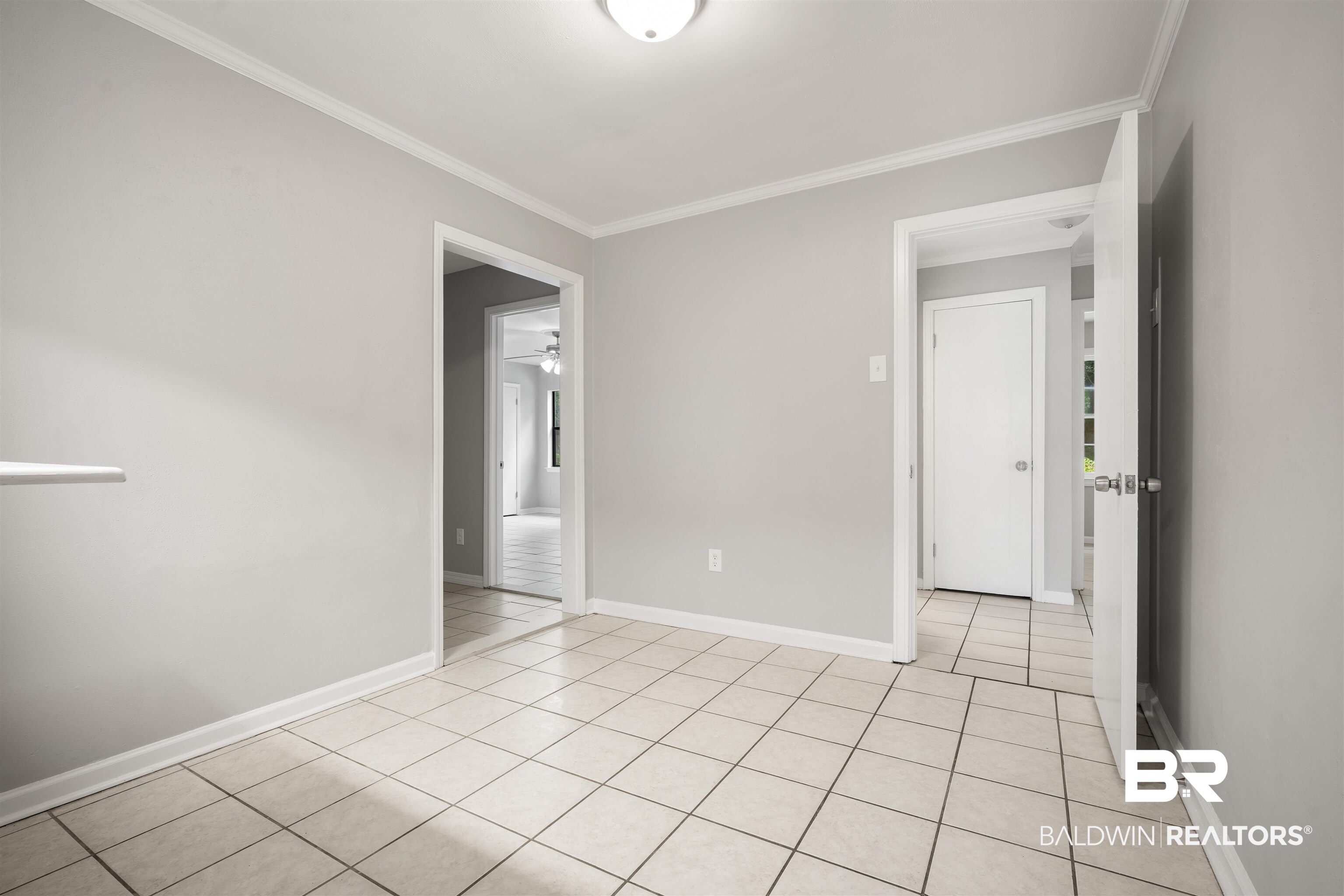 963 Shady Brook Drive Mobile, AL 36606 - Photo 12 of 20 Unfurnished room with ornamental molding, light tile patterned flooring, baseboards, and a ceiling fan