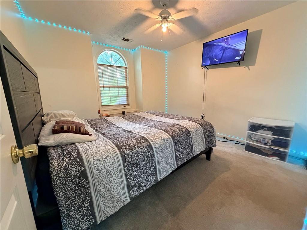 426 Pates Lake Court Hampton, GA 30228 - Photo 20 of 60 a bedroom with a bed and a chandelier