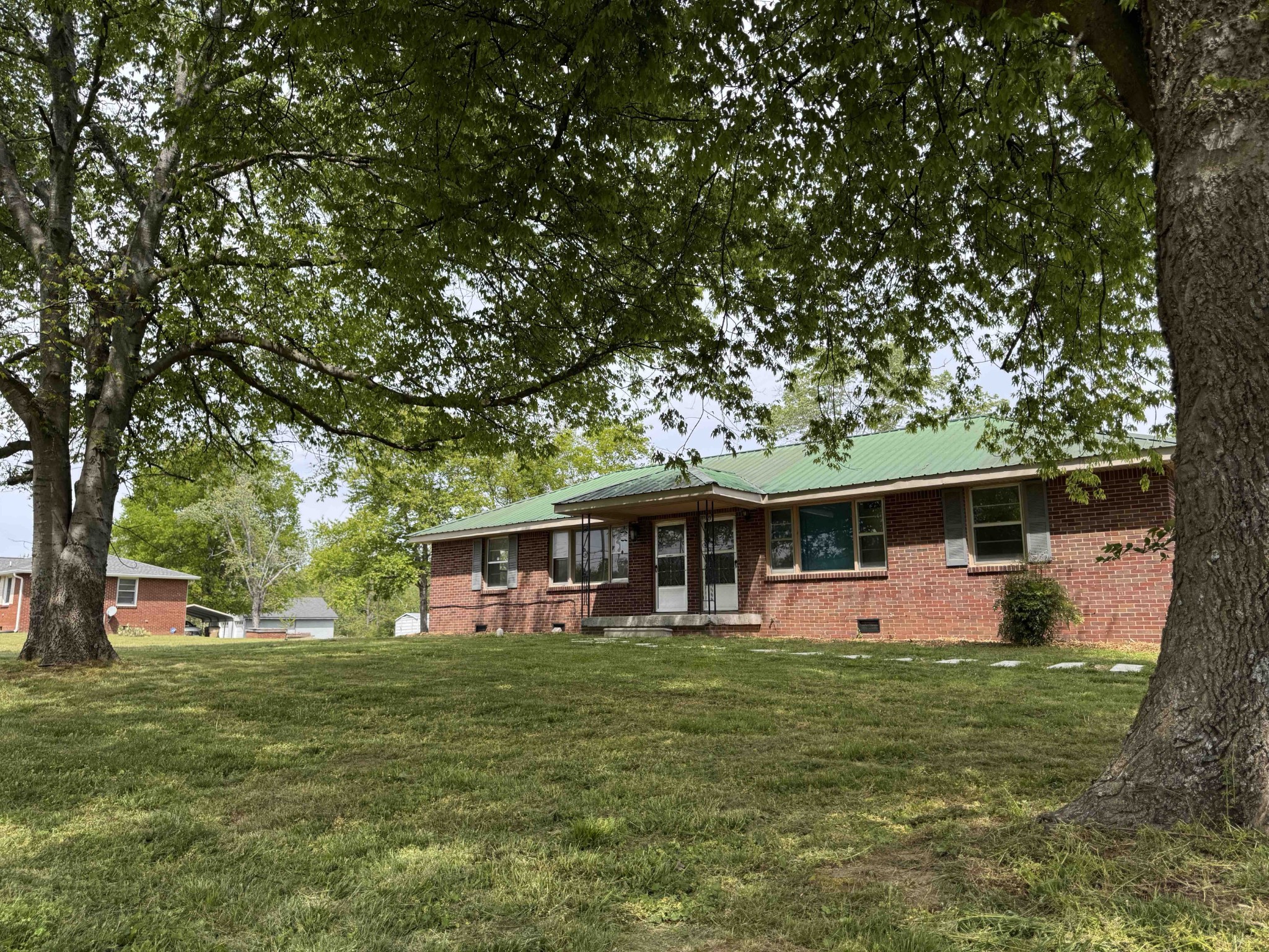 a front view of house with yard and trees