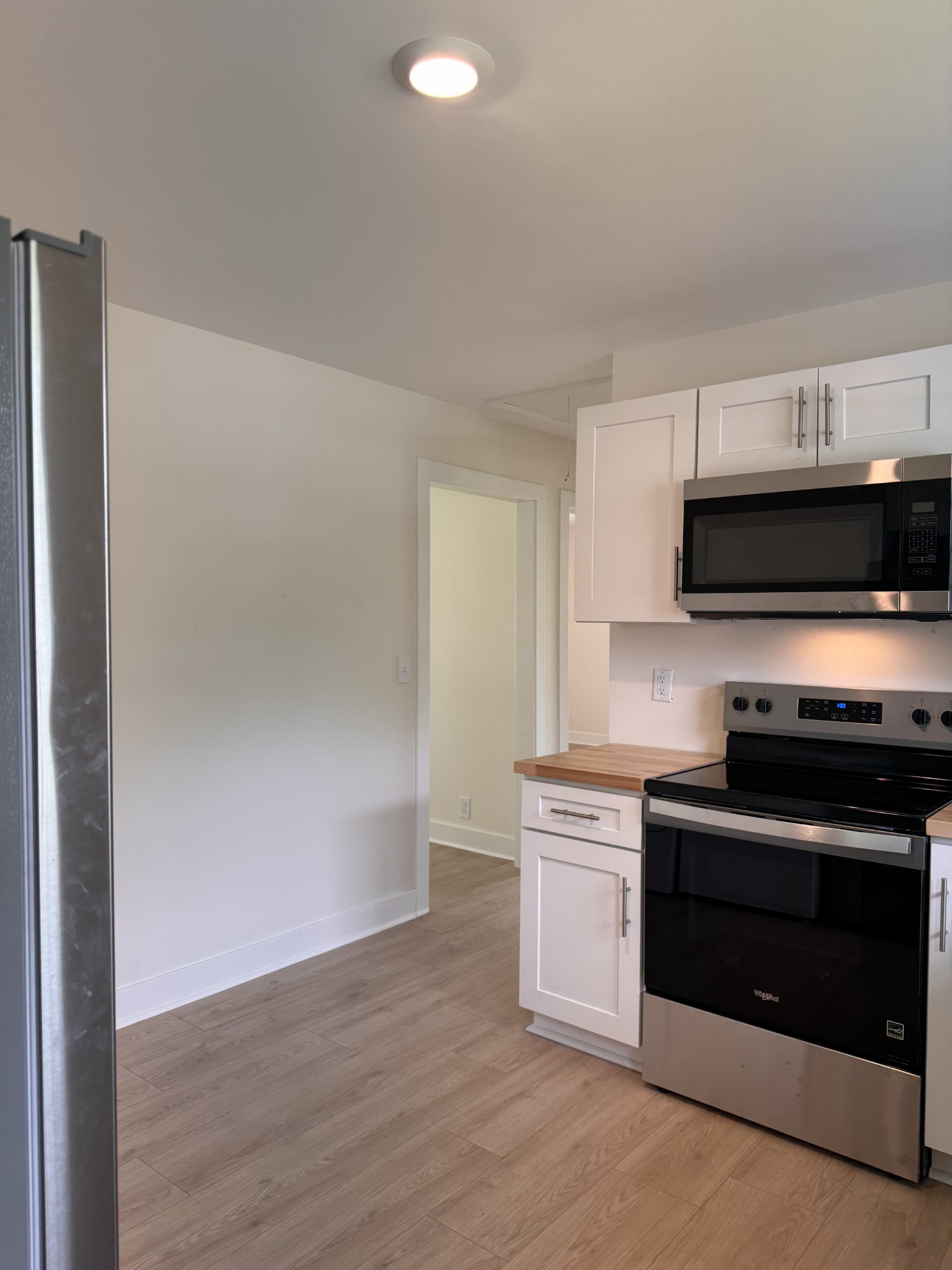 4362 Cato Road Nashville, TN 37218 - Photo 13 of 16 a kitchen with stainless steel appliances a stove a microwave and a hard wood floors