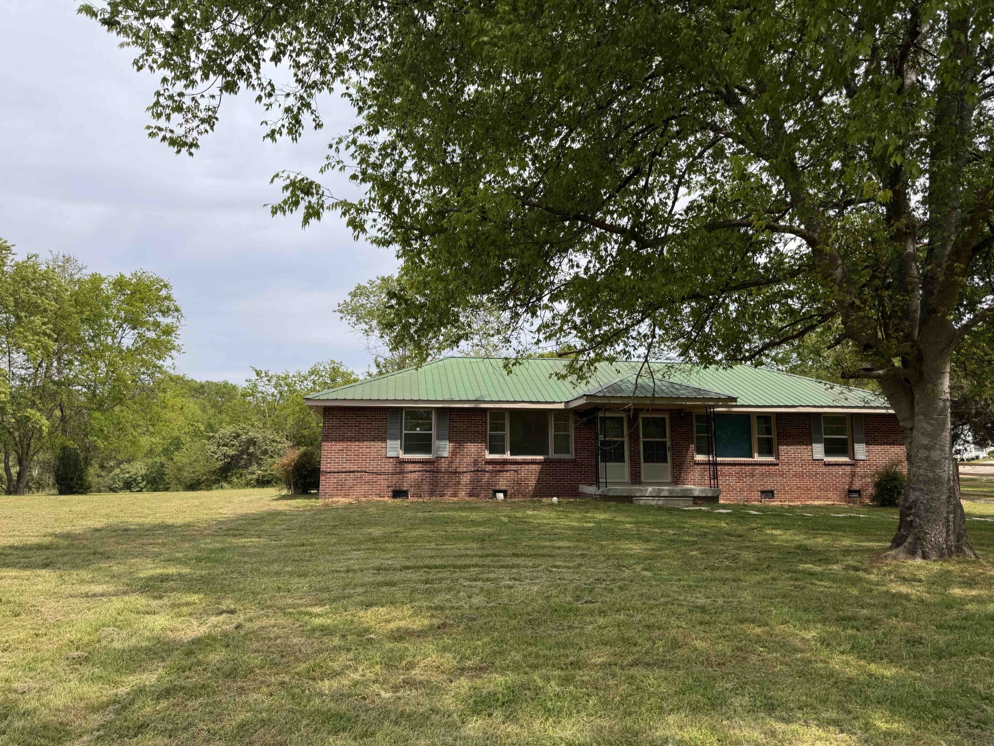 4362 Cato Road Nashville, TN 37218 - Photo 16 of 16 a front view of a house with a garden and trees