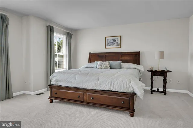 a bed sitting in a bedroom next to a window