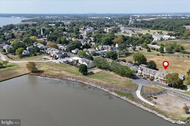 an aerial view of a house with a yard and lake view