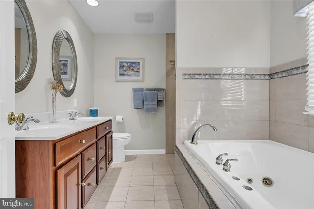 a bathroom with a bathtub a mirror a sink and a shower
