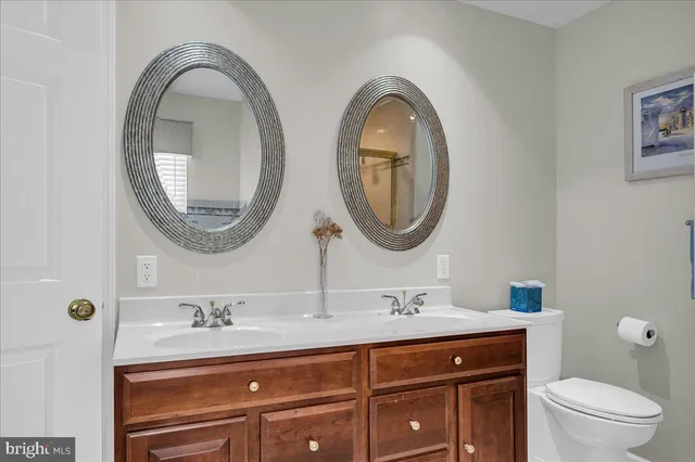 a bathroom with a granite countertop a sink and a mirror