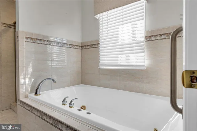 a bathroom with a bathtub and a window