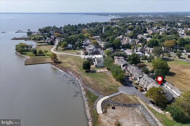an aerial view of a house with a yard basket ball court and outdoor seating