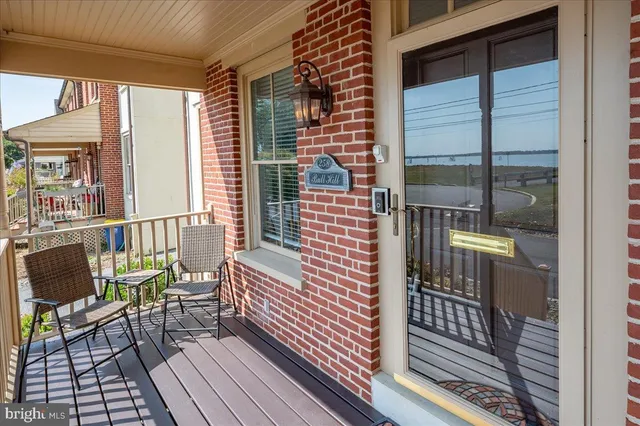a balcony with table and chairs