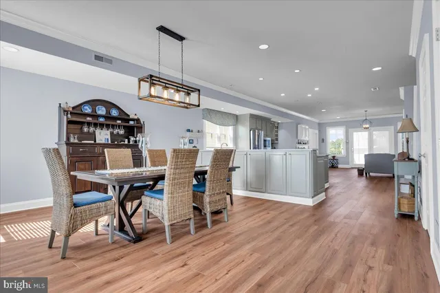 a living room with furniture dining table and wooden floor