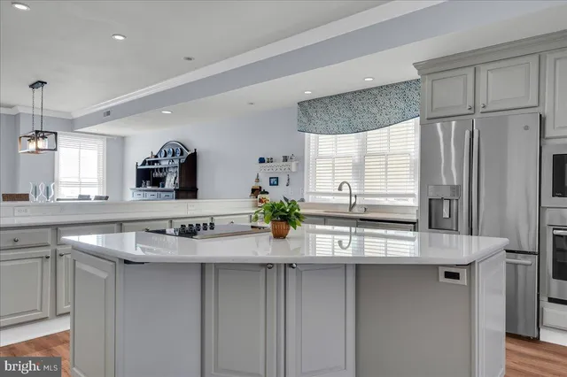 a kitchen with stainless steel appliances granite countertop a sink and a refrigerator