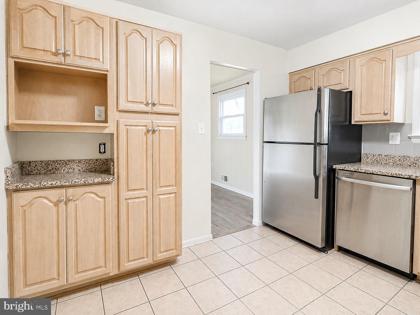 11312 Old Fort Road Fort Washington, MD 20744 - Photo 5 of 13 a kitchen with white cabinets and refrigerator