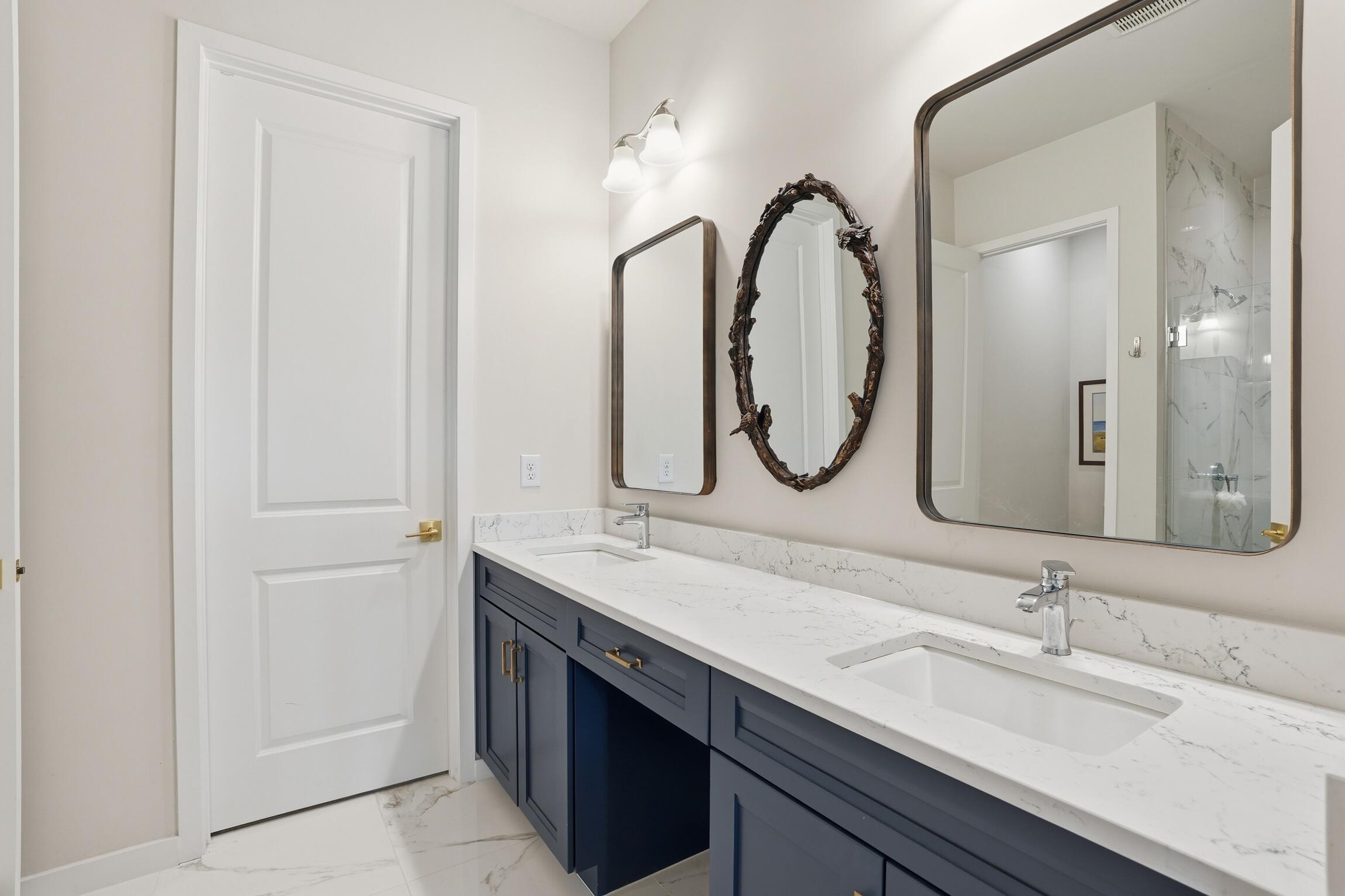14708 Kingfisher Loop Naples, FL 34120 - Photo 22 of 42 a bathroom with a double vanity sink and a mirror