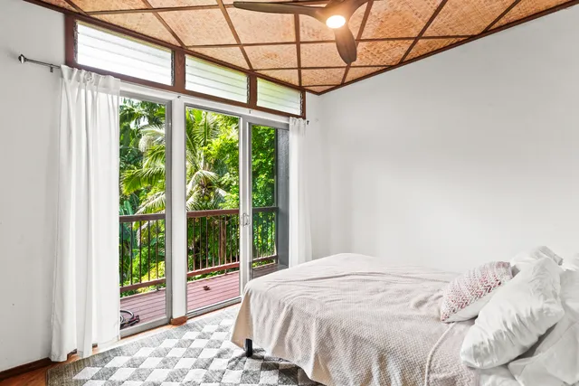 a bedroom with a large bed and a window