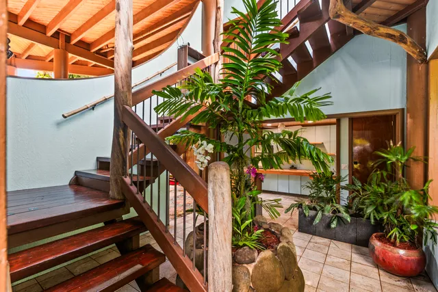a view of a porch with furniture and a backyard