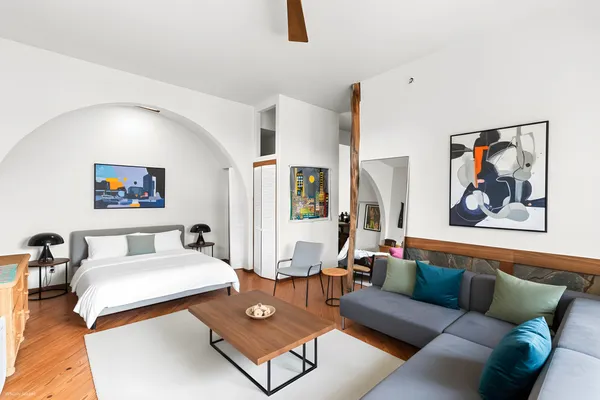 a view of living room with furniture and a rug