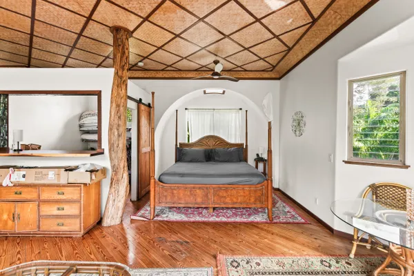 a room with a bed and a wooden floor
