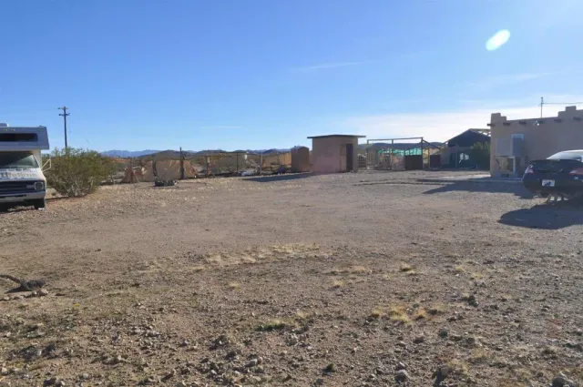 a view of a dry yard with a road