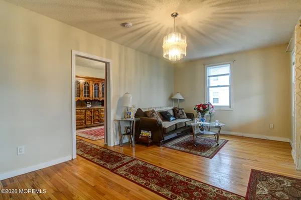 a living room with furniture and a chandelier
