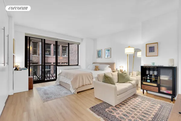 a bedroom with a large bed and a couch
