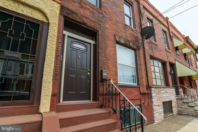 a view of a brick house with a large windows