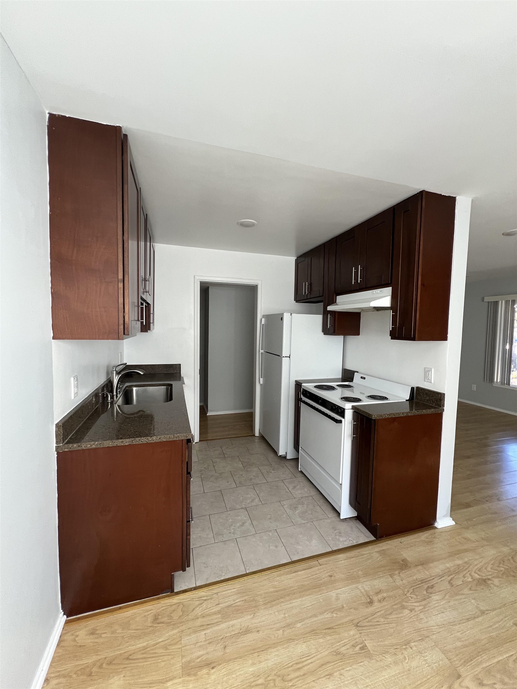 2636 Warring Street, Unit 204 Berkeley, CA 94704 - Photo 9 of 10 a kitchen with stainless steel appliances granite countertop a sink stove and refrigerator