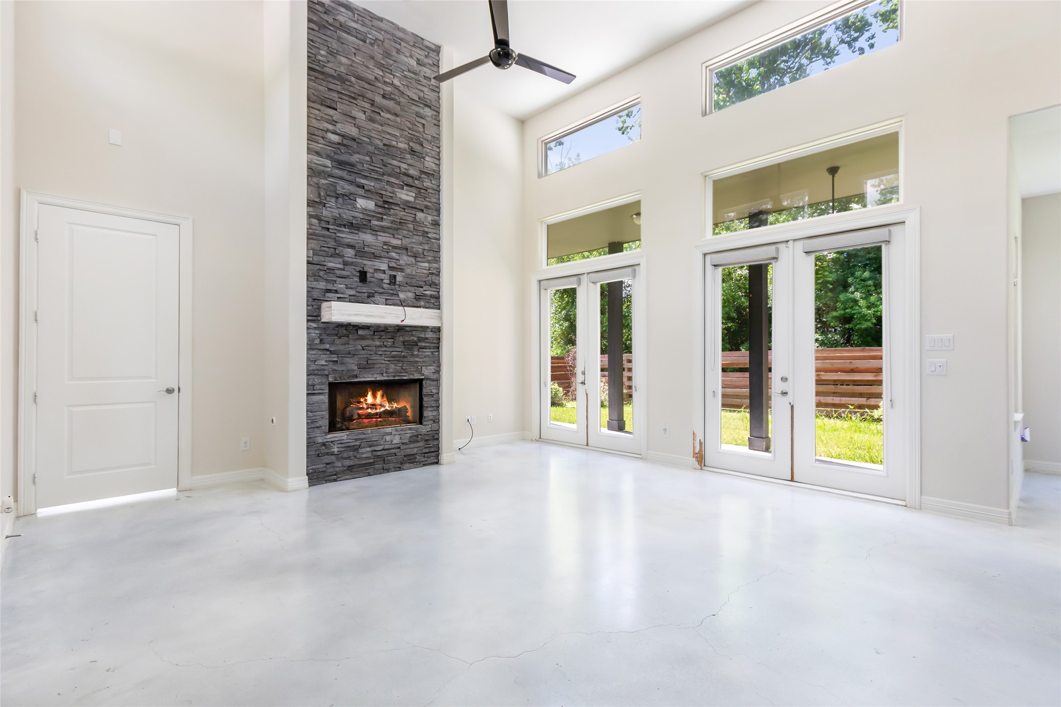 538 Magnolia Point Drive Huffman, TX 77336 - Photo 30 of 30 Contemporary design with stacked stone fireplace focal point. Stained concrete floors, high ceilings, and open floor plan. Cosmetic damage depicted.