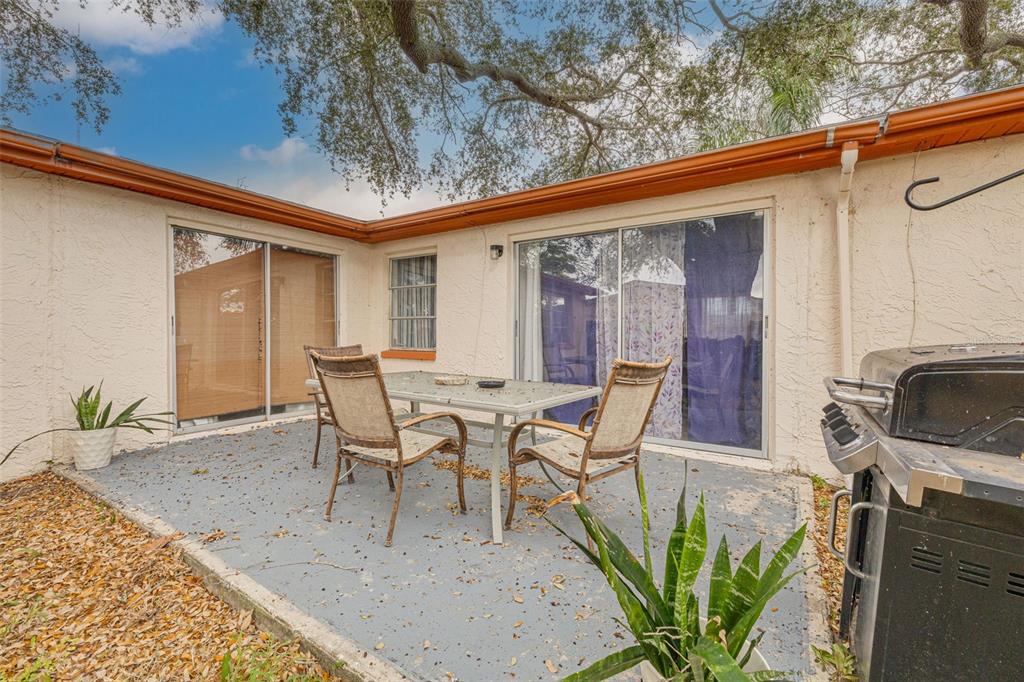 3322 Fairmount Drive Holiday, FL 34691 - Photo 11 of 29 a view of a patio with table and chairs and potted plants