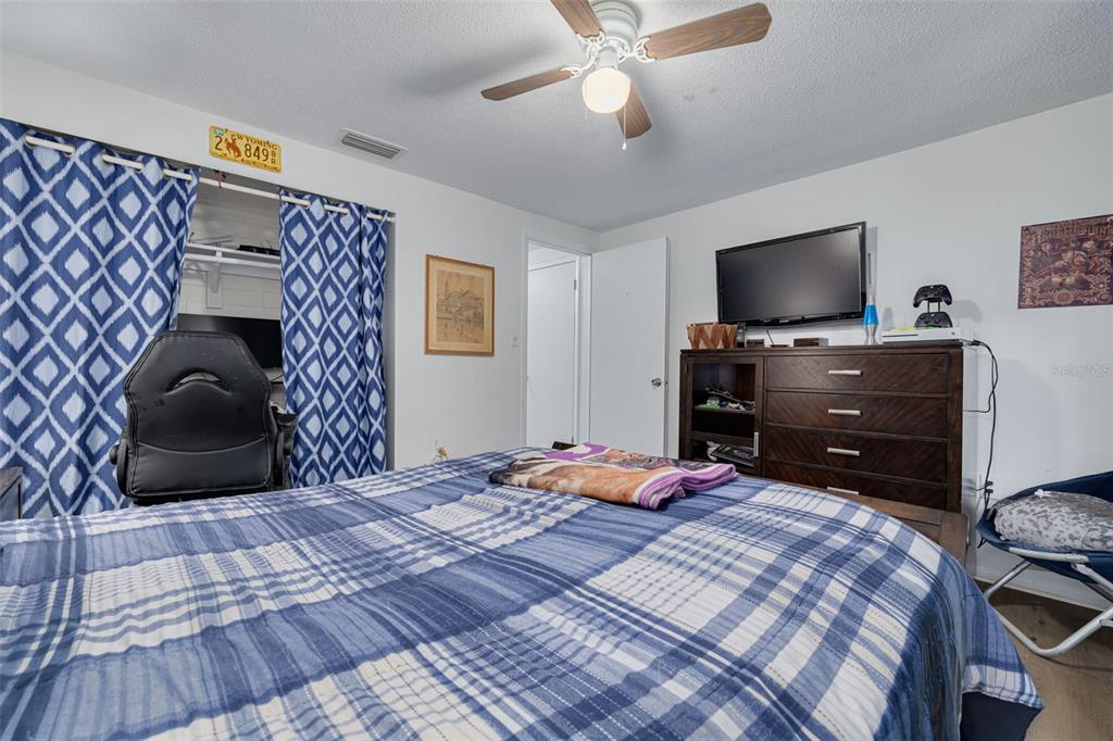 3322 Fairmount Drive Holiday, FL 34691 - Photo 12 of 29 a bedroom with a bed and a flat screen tv
