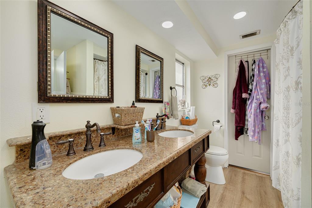 3322 Fairmount Drive Holiday, FL 34691 - Photo 14 of 29 a bathroom with double vanity sinks a mirror and a shower