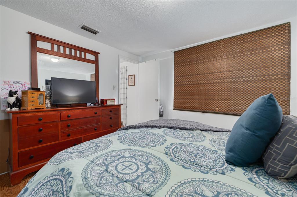 3322 Fairmount Drive Holiday, FL 34691 - Photo 18 of 29 a bedroom with a bed and a flat screen tv