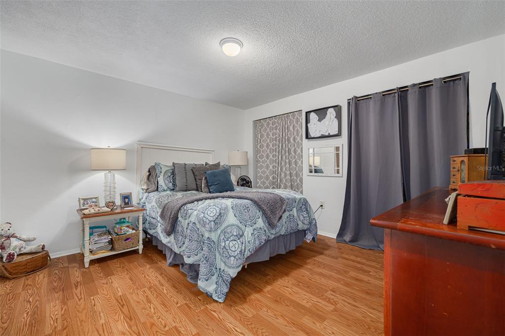 3322 Fairmount Drive Holiday, FL 34691 - Photo 19 of 29 a bedroom with a bed and a dresser with wooden floor