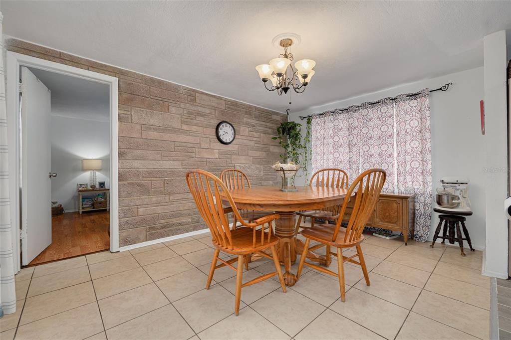 3322 Fairmount Drive Holiday, FL 34691 - Photo 21 of 29 a view of a dining room with furniture and chandelier