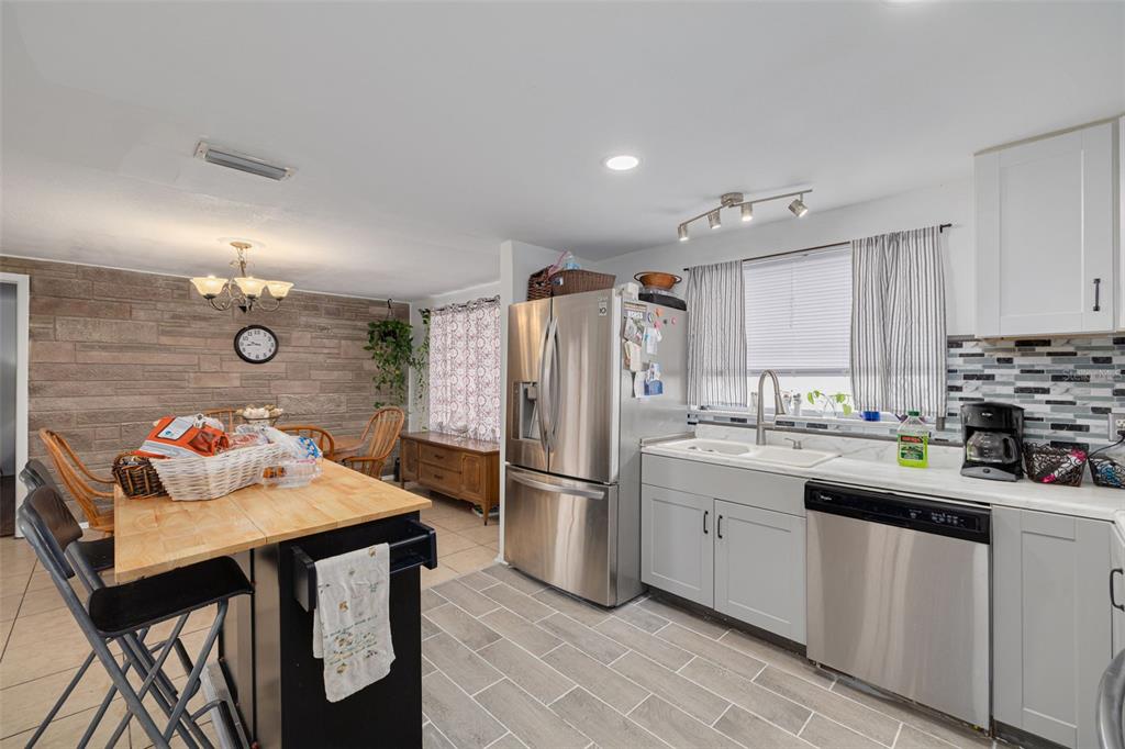 3322 Fairmount Drive Holiday, FL 34691 - Photo 22 of 29 a kitchen with refrigerator a sink and cabinets