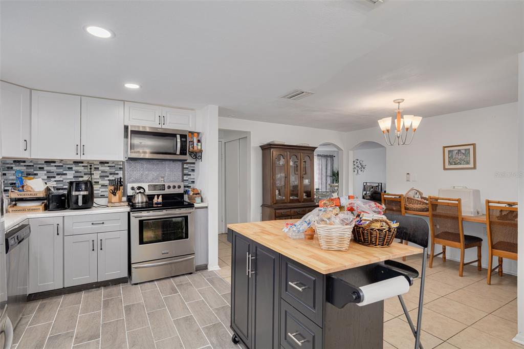 3322 Fairmount Drive Holiday, FL 34691 - Photo 23 of 29 a kitchen with granite countertop a sink counter top space appliances and cabinets