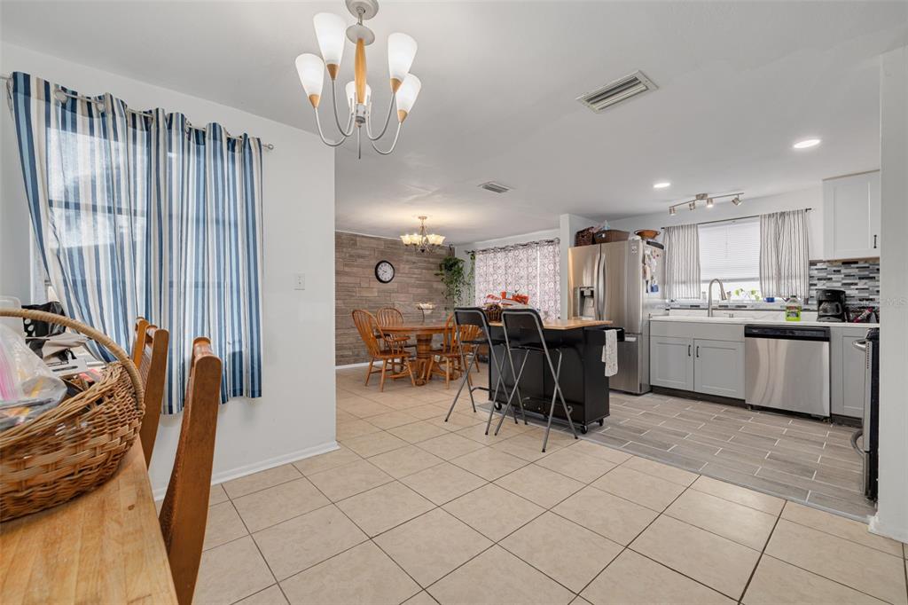 3322 Fairmount Drive Holiday, FL 34691 - Photo 25 of 29 a kitchen with stainless steel appliances a table and chairs in it
