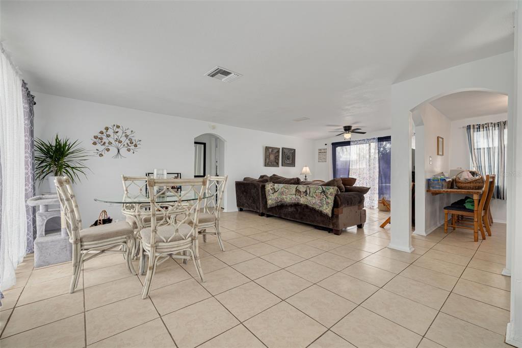 3322 Fairmount Drive Holiday, FL 34691 - Photo 28 of 29 a living room with furniture and a dining table with kitchen view
