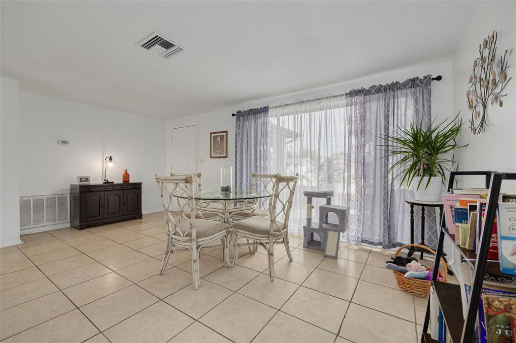 3322 Fairmount Drive Holiday, FL 34691 - Photo 29 of 29 a living room with furniture a flat screen tv and a potted plant