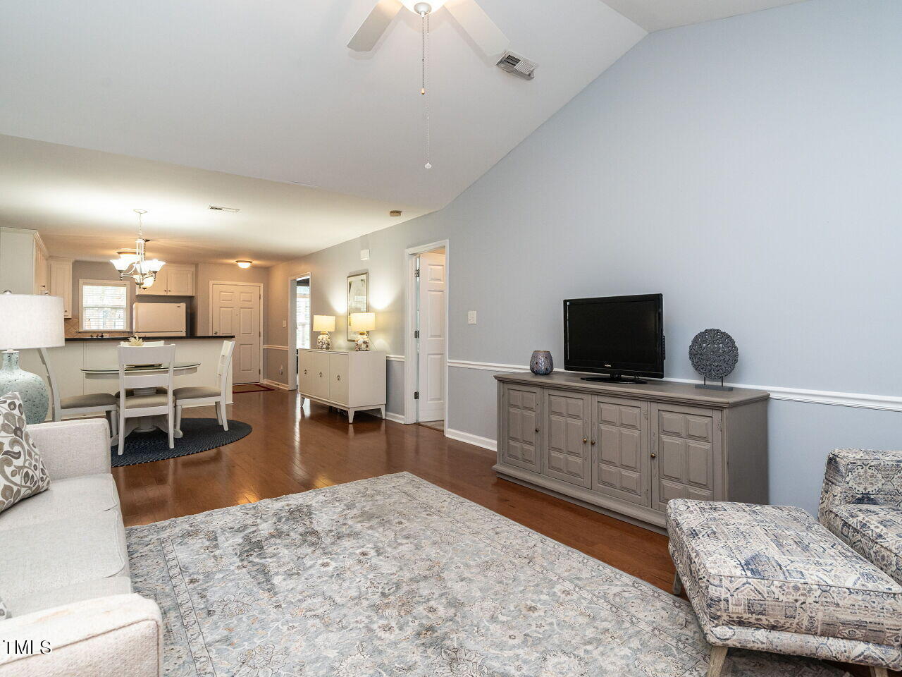 585 Pinecroft Drive Clayton, NC 27520 - Photo 11 of 26 a living room with furniture and a flat screen tv