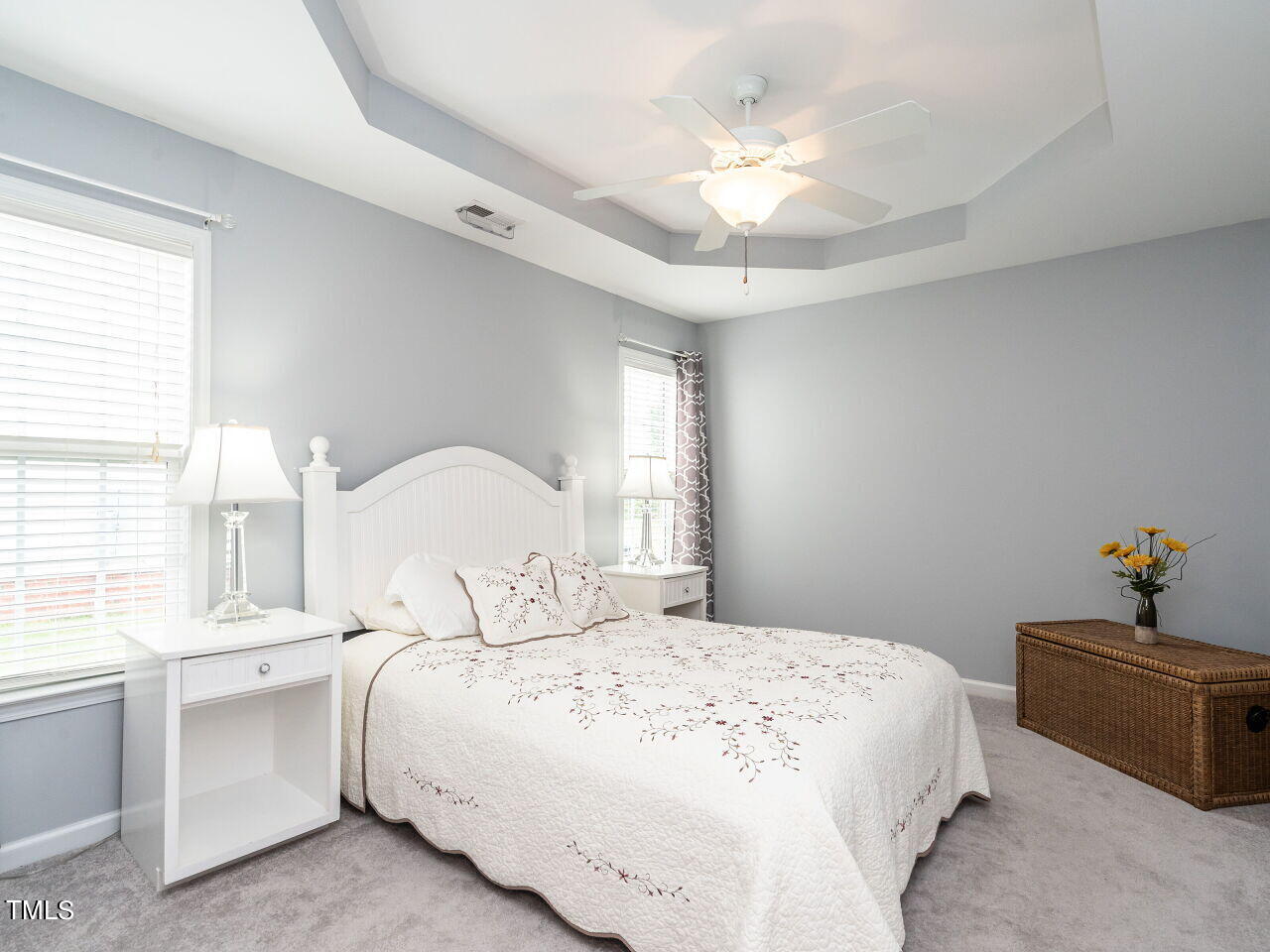 585 Pinecroft Drive Clayton, NC 27520 - Photo 13 of 26 a bedroom with a bed and a chandelier