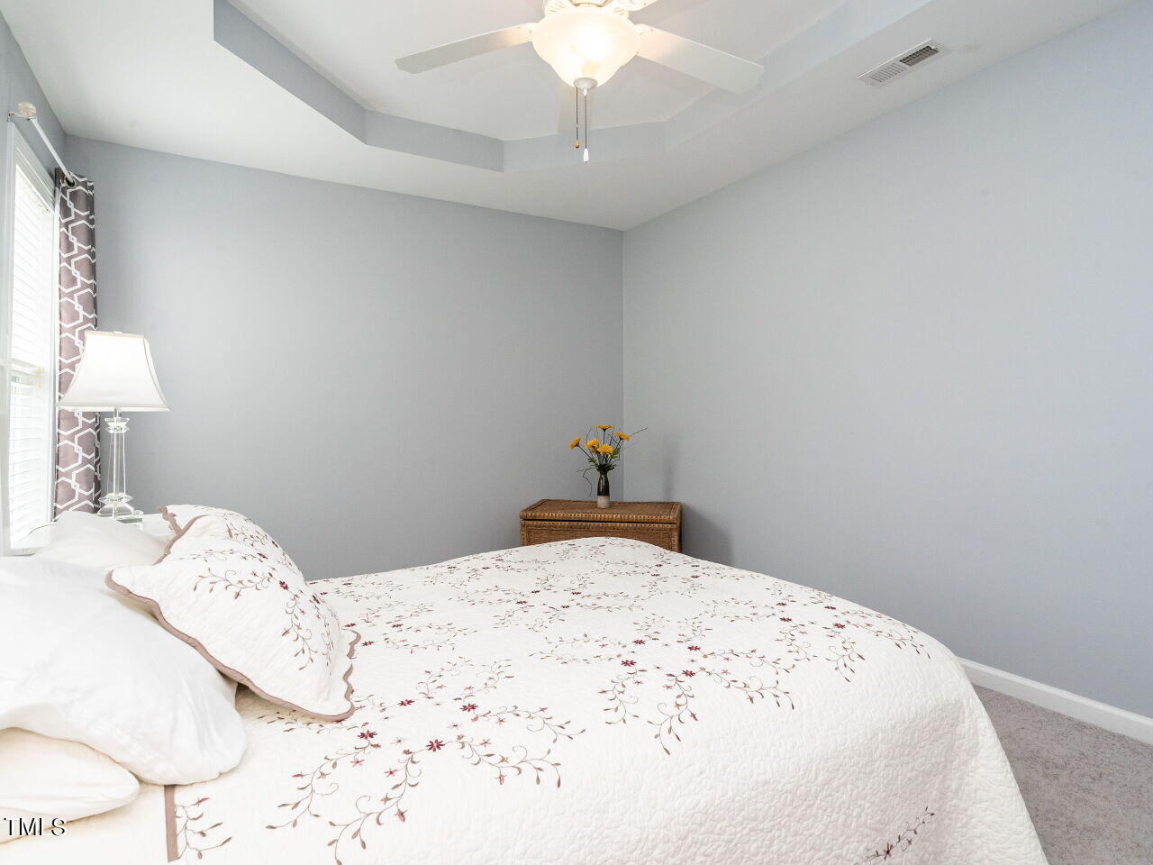 585 Pinecroft Drive Clayton, NC 27520 - Photo 14 of 26 a bedroom with a bed and a chandelier