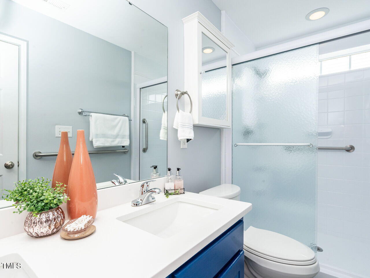 585 Pinecroft Drive Clayton, NC 27520 - Photo 16 of 26 a bathroom with a sink vanity mirror and toilet